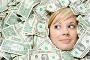 Women peeking through cash