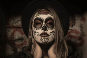 Woman with Mexican skull mask