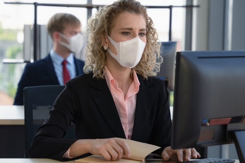 Businesswoman with mask at work
